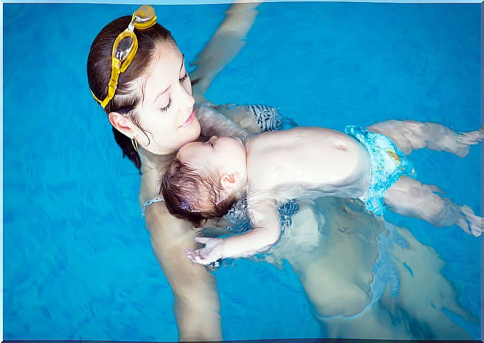 Babies swimming with their mothers.