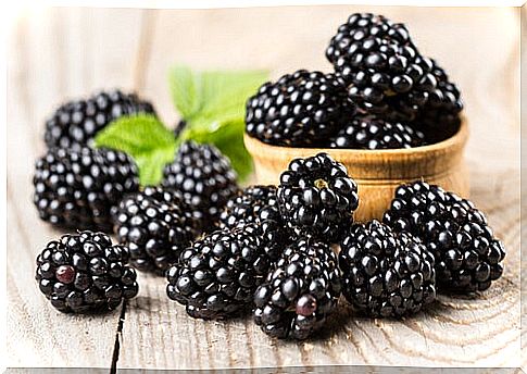 Blackberries and green leaves.