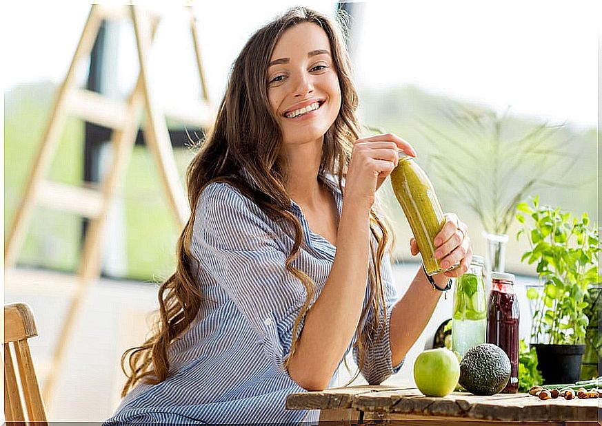 Woman sitting at the table with fruits.