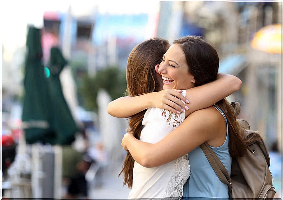 Friends giving each other a hug symbolizing when one helps others