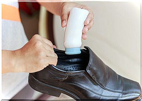 Woman putting powder on shoes: cleaning leather shoes