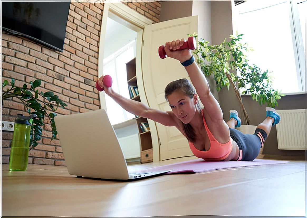 Superman exercise with dumbbells.