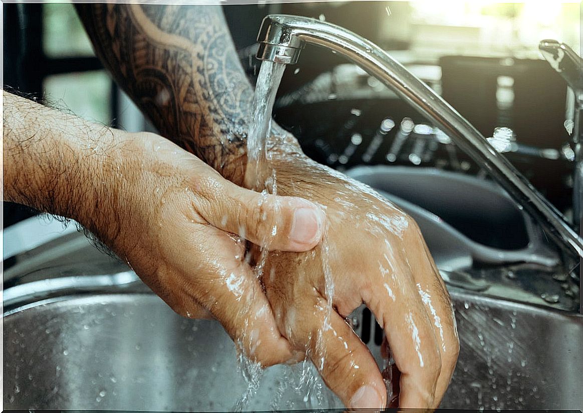 Washing an arm to take care of the tattoo.