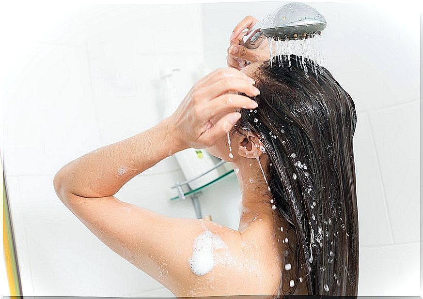 Woman taking shower with hot water